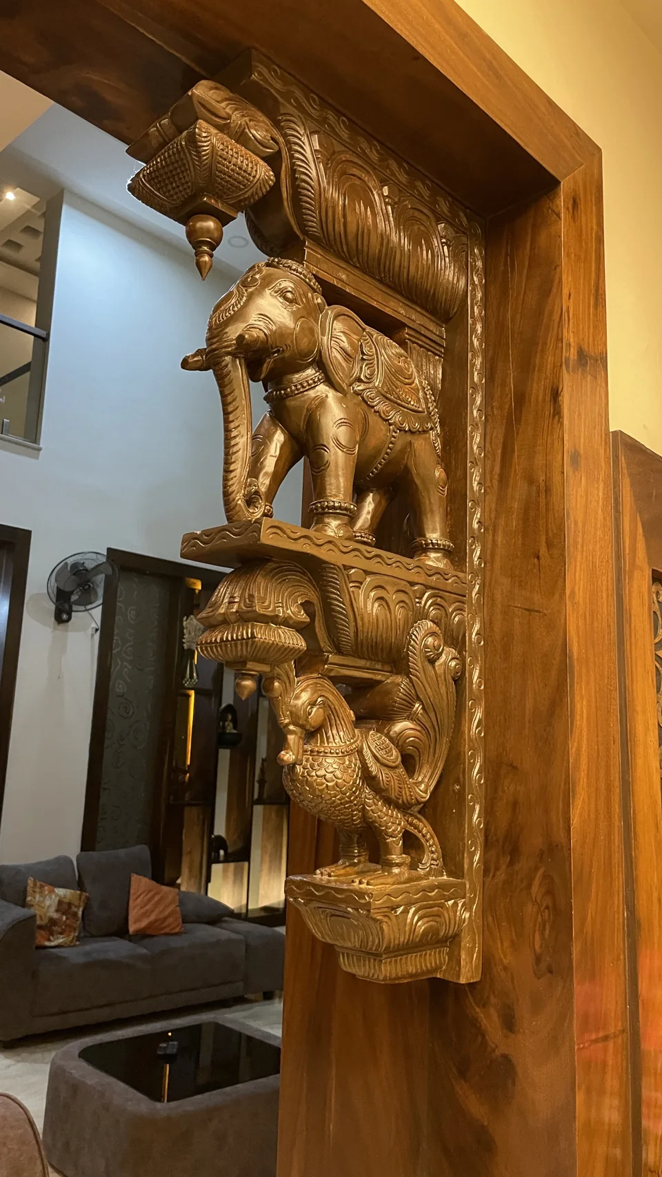 Carved timber bracket with elephant figures set into a doorway frame
